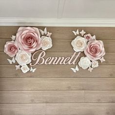 there is a wall with flowers on it and the name bennett written in large letters