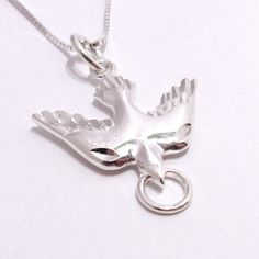 Sterling Silver Holy Peace Dove With Ring Harmony Bird Pendant Necklace This Beautiful Holy Peace Dove With Ring Harmony Bird Sterling Silver Necklace Comes With A .925 Sterling Silver 20 Inch Chain And The Holy Peace Dove With Ring .925 Sterling Silver Pendant. The Pendant Measures 1 Inch High And 7/8 Inches Wide. Cn 1-0104 Mixed Stone Necklace, Semi Precious Necklace, Hand Beaded Necklace, Glowing Necklace, Paw Print Necklace, Shark Tooth Necklace, Peace Dove, Nautical Jewelry, Bird Pendant