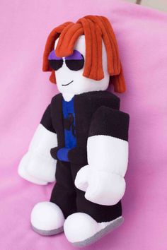 a stuffed toy with red hair and sunglasses