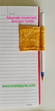 a notepad with a pen and paper on it next to a yellow piece of cloth