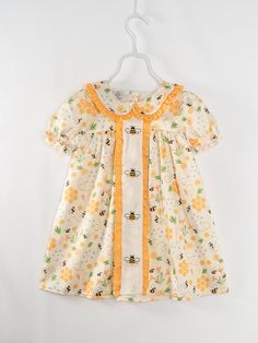 Make a timeless fashion statement with this Bee Floral Vintage Ruffle Girl Dress! Featuring a dainty floral print and buzzing bee motif, it puts a fun and unique twist on a classic style. Perfect for making your mini fashionista stand out! Buzz-worthy and beautiful - just like her! 95% Polyester, 5% Spandex The 'milk silk' feel of the material is a blend of Cotton/Polyester/spandex. The pattern is referred to as "milk silk" a super soft, comfortable, buttery feel material- you will fall in love! Bumble Bee Dress, Girls Boutique Dresses, Easter Dresses For Toddlers, Girls Ruffle Dress, Bee Dress, Childrens Clothing Boutique, Baby Dress Design, Baby Frocks Designs