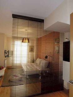 a bedroom with wooden floors and sliding glass doors on the wall to let in light