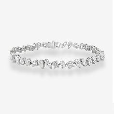 This bracelet is a must-have for any fashion-forward jewelry collection! It features various diamond shapes, including round, oval, pear, marquise, and emerald cuts, all prong set in high-polished 18K white gold. Create an opulent and stunning look by pairing this with any of our Diamond Classics. Natural Diamonds: 9.80ctw 18K White Gold Length: 7 1/4 Inches Mavilo Exclusive Diamond Tennis Bracelet, Tennis Bracelet Diamond, Tennis Bracelet, Diamond Shapes, Prong Setting, Natural Diamonds, Pear, Fashion Forward, Jewelry Collection