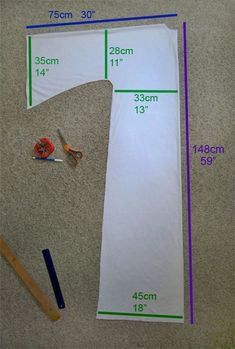 sewing supplies laid out on the floor with measurements