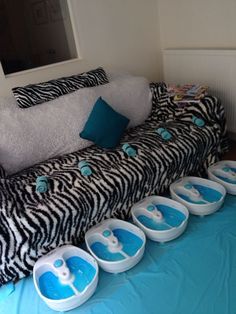 a couch that has been decorated with blue and white bowls on the top of it