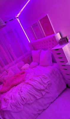 a bedroom with purple lighting and a bed in the middle is lit up by pink lights