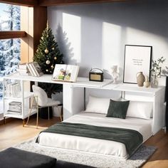 a white bed sitting under a window next to a desk with a christmas tree on it