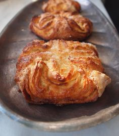 three pastries sitting on top of a metal pan