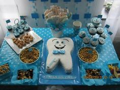 a table topped with lots of cupcakes and treats