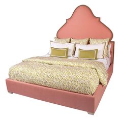 a bed with two pillows on top of it and a pink headboard in the middle