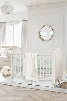 a baby's room is decorated in white and neutrals, including the crib