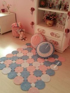 a pink and blue rug with circles on the floor