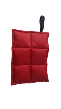 a red square pillow hanging from the side with a black hook on it's end