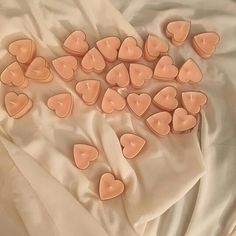 small hearts are arranged on a white sheet