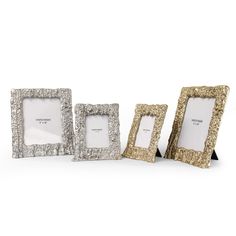 three silver and gold frames sitting next to each other