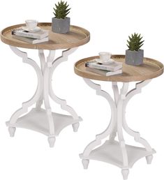 two small tables with plants on them sitting next to each other