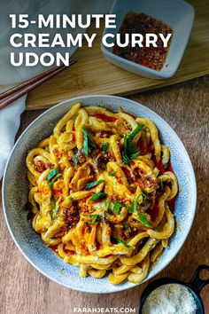 a bowl filled with pasta and sauce on top of a wooden table