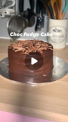 a chocolate cake sitting on top of a wooden table