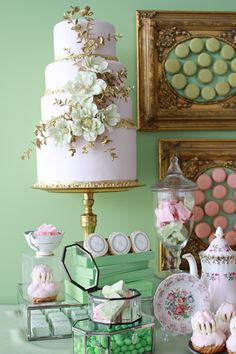 a table topped with lots of different types of cakes and cupcakes on top of it