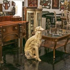 a dog statue sitting in front of a glass table