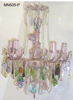 a pink chandelier with lots of glass beads hanging from it's sides