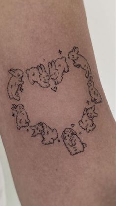 a heart shaped tattoo with cats and dogs on it