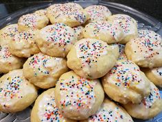 a platter full of iced cookies with sprinkles