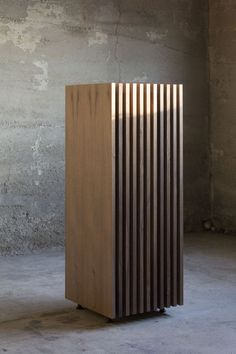 a wooden object sitting on top of a cement floor