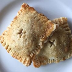 two pieces of pie on a white plate