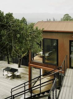 a wooden deck with stairs leading up to a house