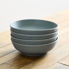 four gray bowls stacked on top of each other