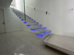 there is a set of stairs with blue lights in the bottom and bottom steps on each side