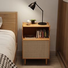 a nightstand with a lamp and books on it next to a bed