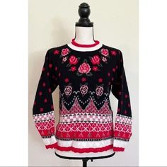 a black and red sweater with roses on it