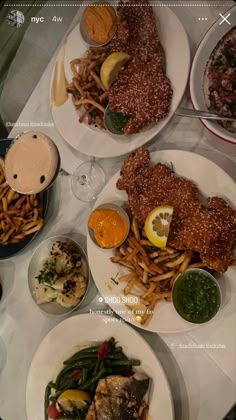 four plates with different types of food on them, including fish and french fries in sauces