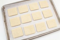 the pan is filled with squares of dough on top of a white countertop, ready to be baked