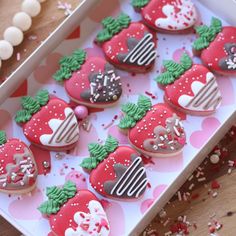 decorated heart shaped cookies in a box on a table