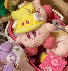 two stuffed animals in a pink basket with other toys on the shelf behind them,