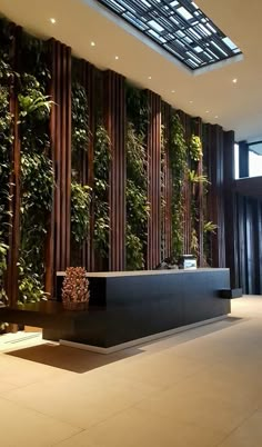 an office lobby with plants growing on the wall