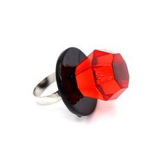 a red and black ring sitting on top of a white surface