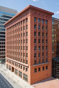 an old brick building in the middle of a city