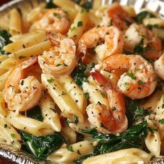 pasta with shrimp and spinach in a bowl