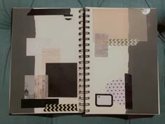 an open notebook with black and white papers on it