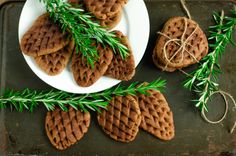 delicious holiday cookies with ginger snap and pinecone sprigs on a white plate