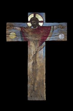 a wooden cross with a painting of jesus on it