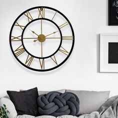 a living room filled with furniture and a large clock on the wall above it's head