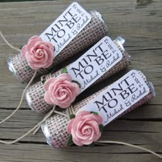 three rolls of twine with pink roses on them