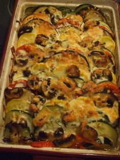 a casserole dish filled with vegetables and cheese