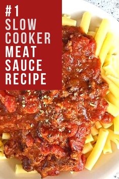 a white plate topped with pasta covered in meat and sauce next to a red sign that says slow cooker meat sauce recipe