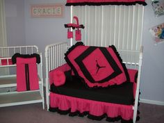 a pink and black crib bedding set